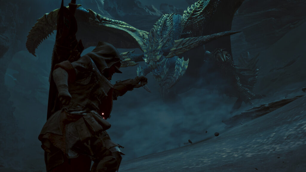 Monster Hunter Wilds - Cazador enfrentandose a un monstruo volador en una cueva - Juegosrpg.com