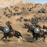 Mount & Blade II Bannerlord - jinetes con escudo cargando por el desierto en plena batalla - Juegosrpg.com