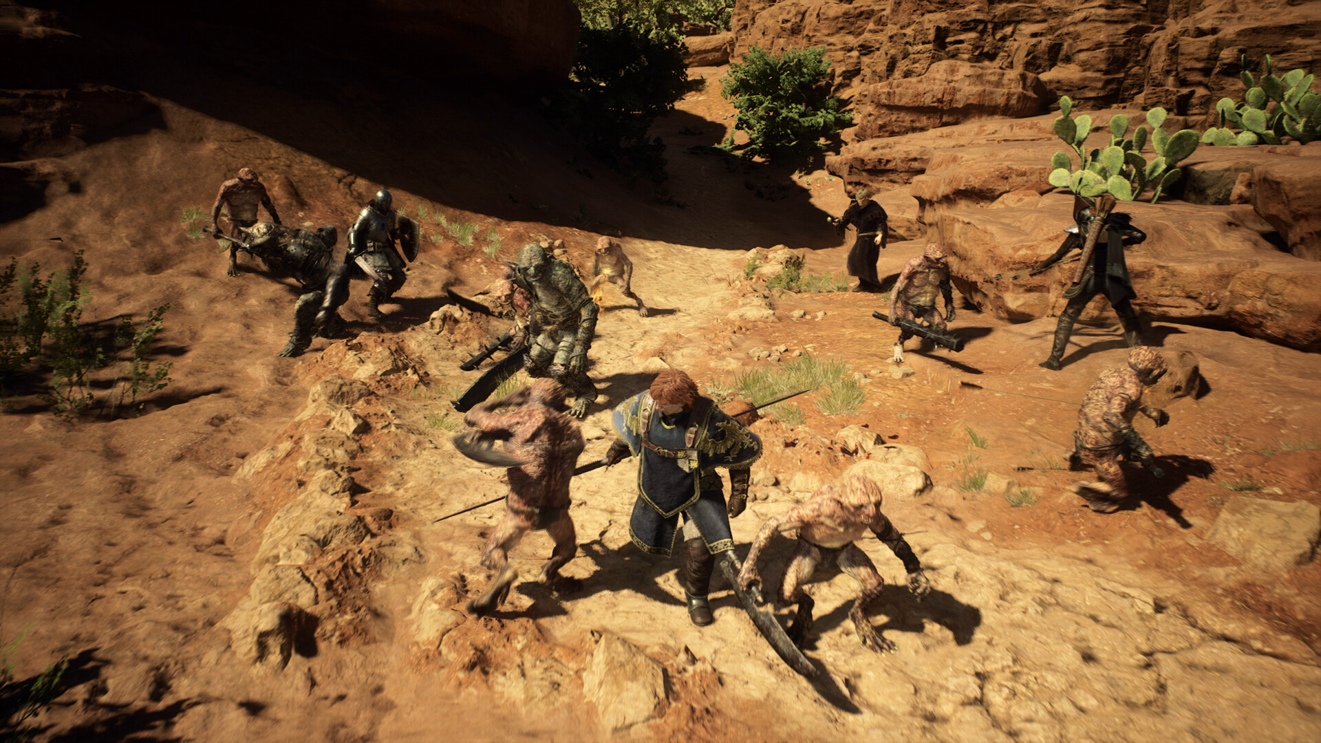Dragon's Dogma 2 - grupo de aventureros enfrentándose a enemigos en un cañón de tierra rojiza - Juegosrpg.com